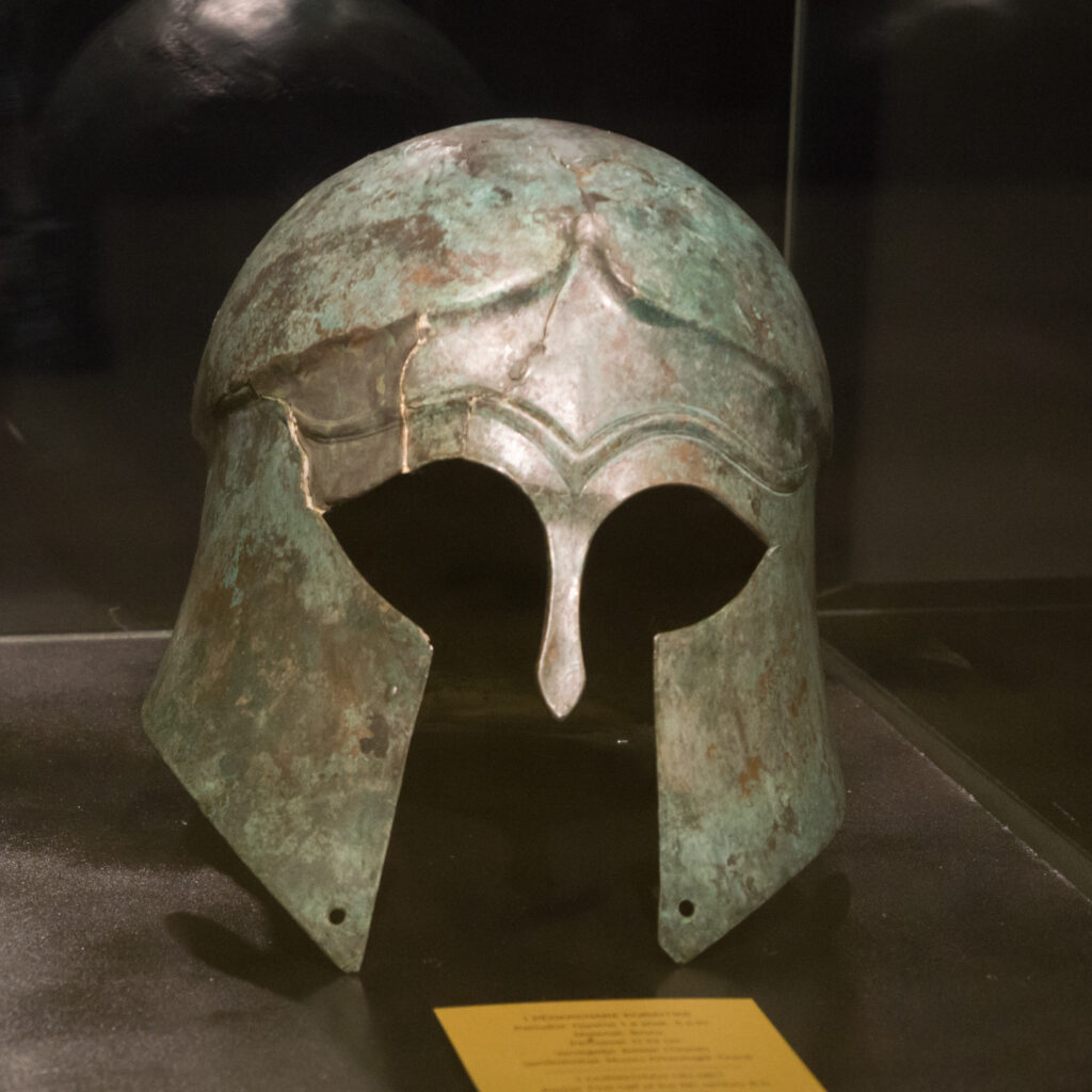 Spartan bronze helmet with cheek guards, museum display