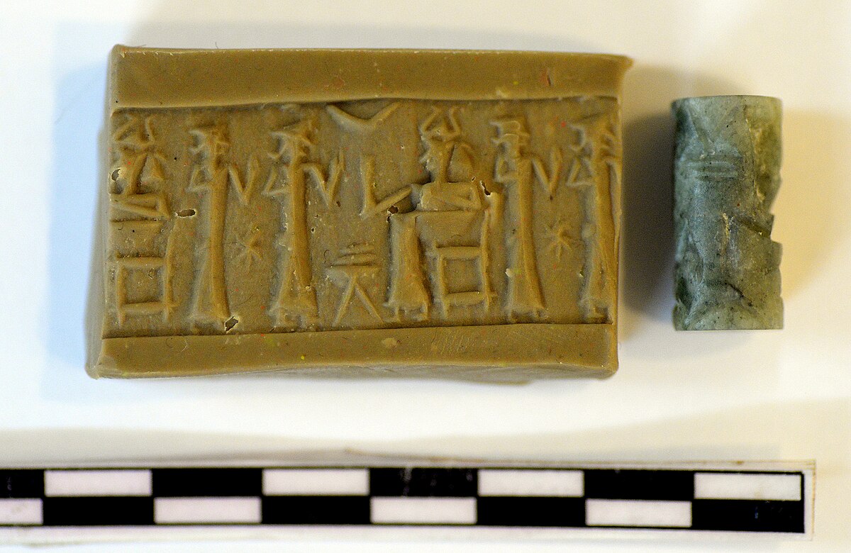 Cylinder seal impression with deities and a gate-like motif
