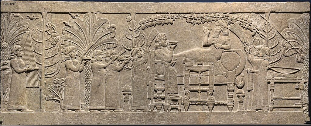 Banquet scene where a severed enemy head hangs from a tree