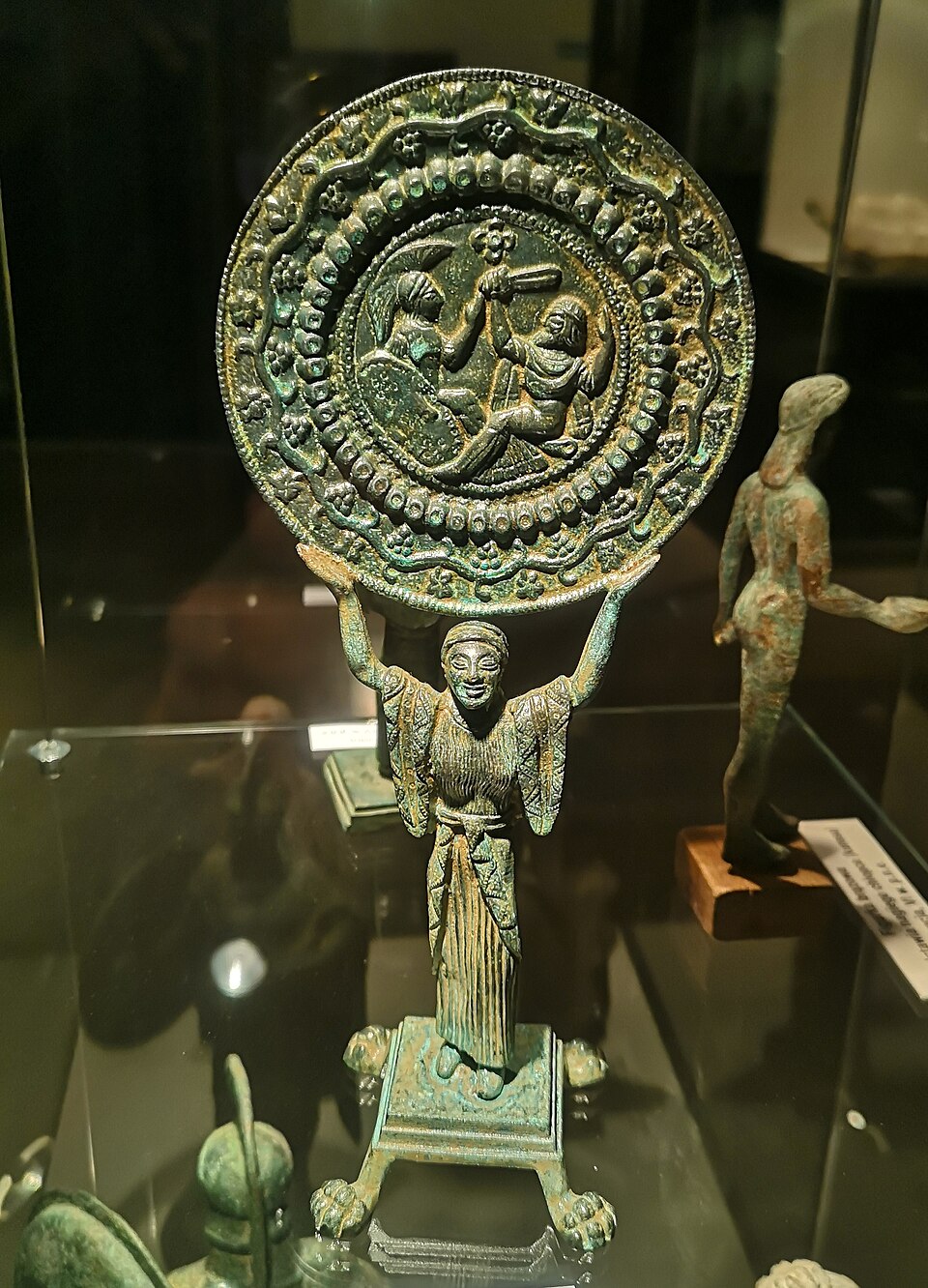Bronze Etruscan mirror engraved with mythological scene.