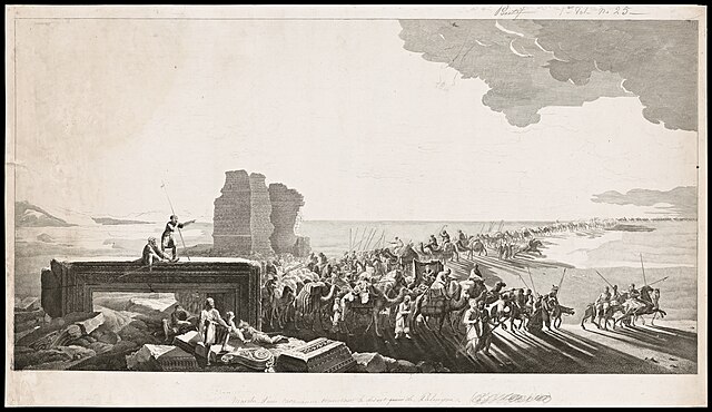 Camel train near the ruins of Palmyra against a desert backdrop