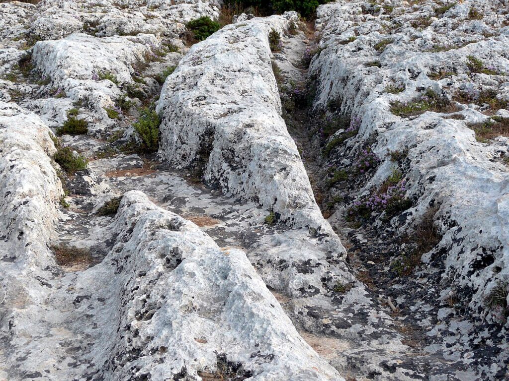 Close view of deep parallel grooves with steady gauge at Misraħ Għar il-Kbir