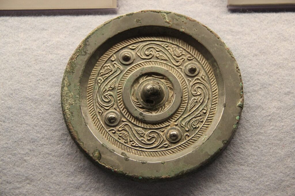 Han bronze mirror with rich back relief.