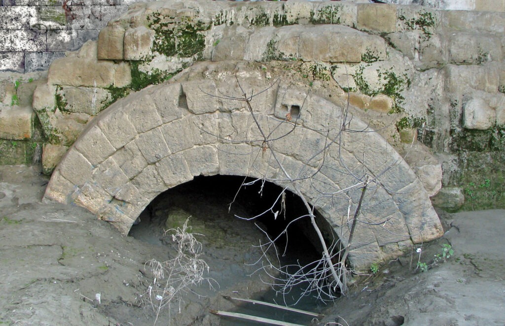 Ancient Infrastructure: arched stone outlet of the Cloaca Maxima sewer into the Tiber
