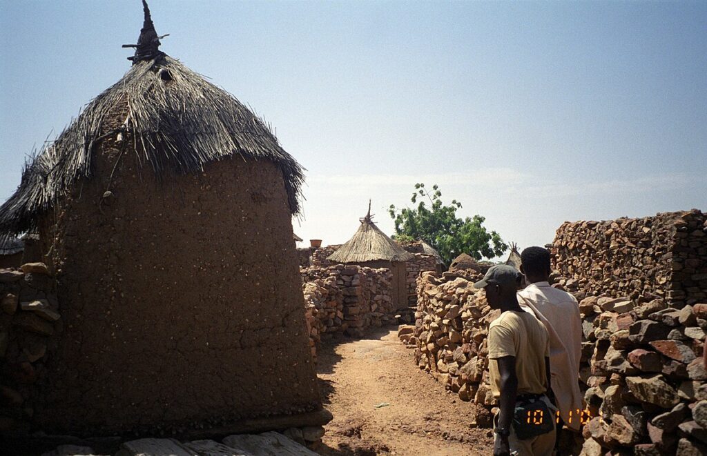 Octagonal Dogon granary with thatched cap in a village at the foot of the escarpment