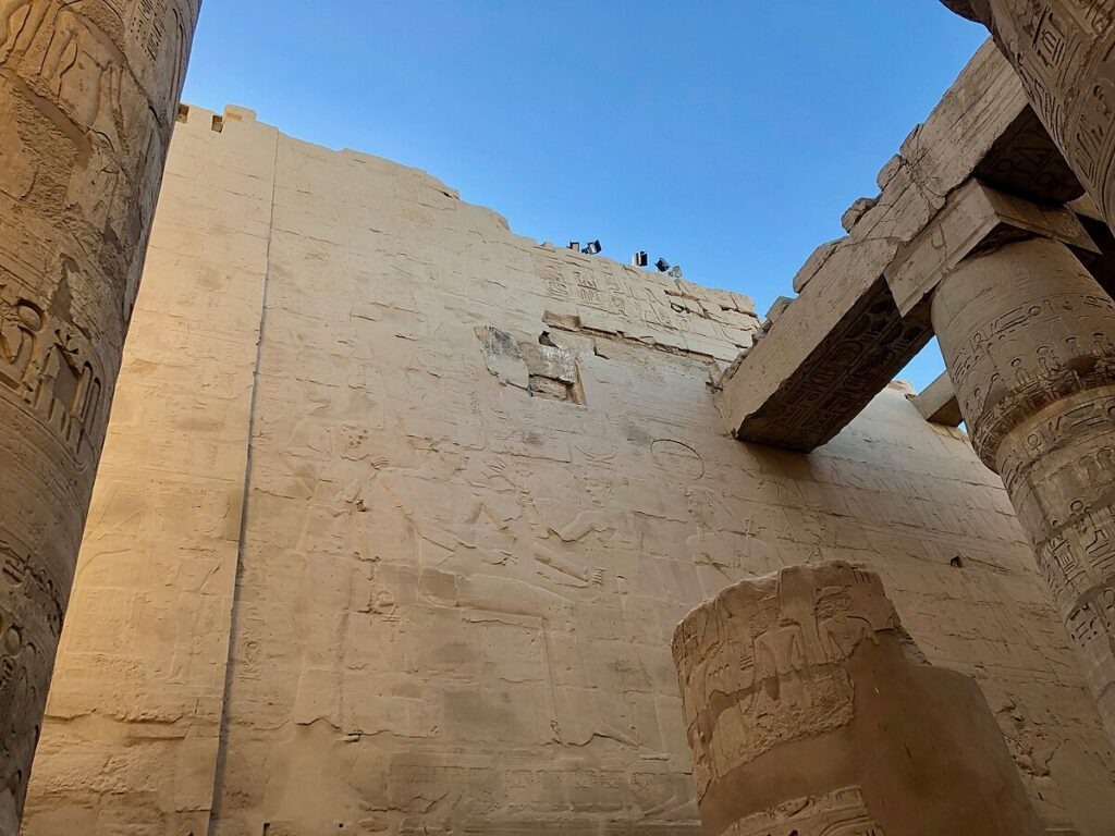 Hypostyle hall at Karnak with towering papyrus-bundle columns and dappled light