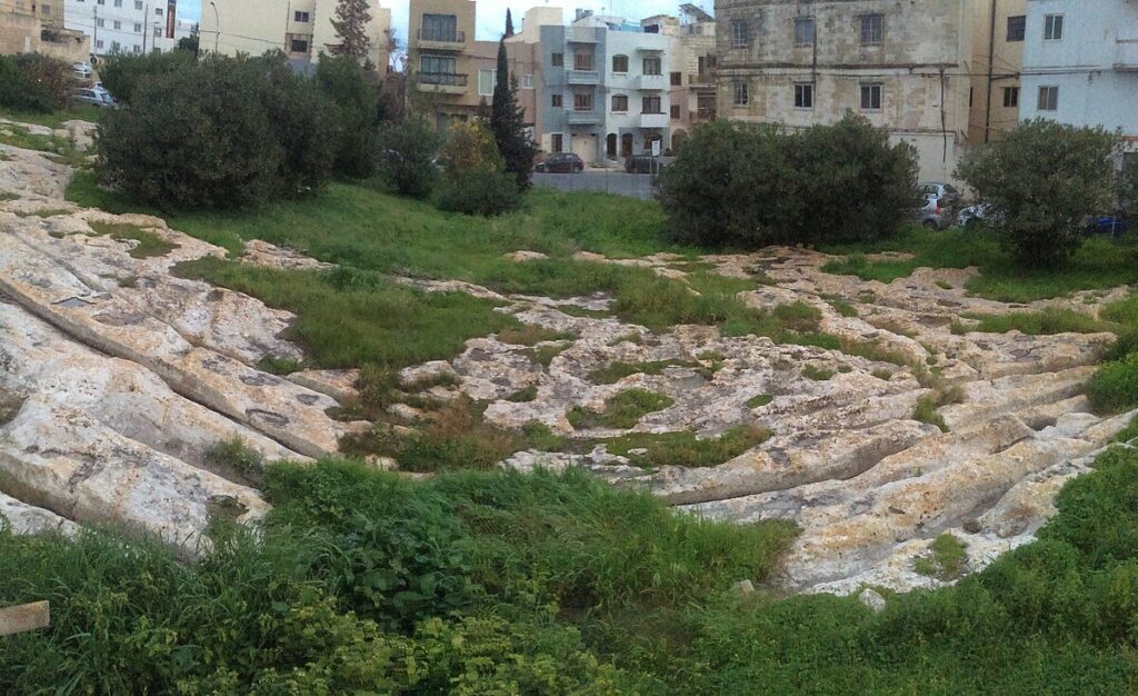 Cart ruts running through a suburban setting at Mensija