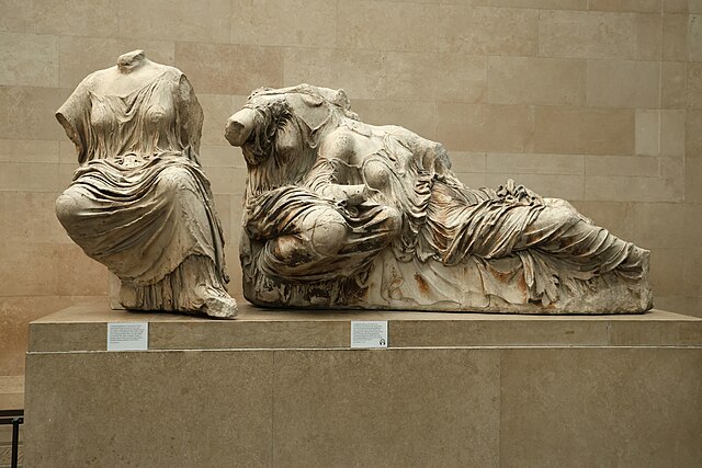 Classical marble sculpture fragments from a temple pediment, showing gods in dynamic poses
