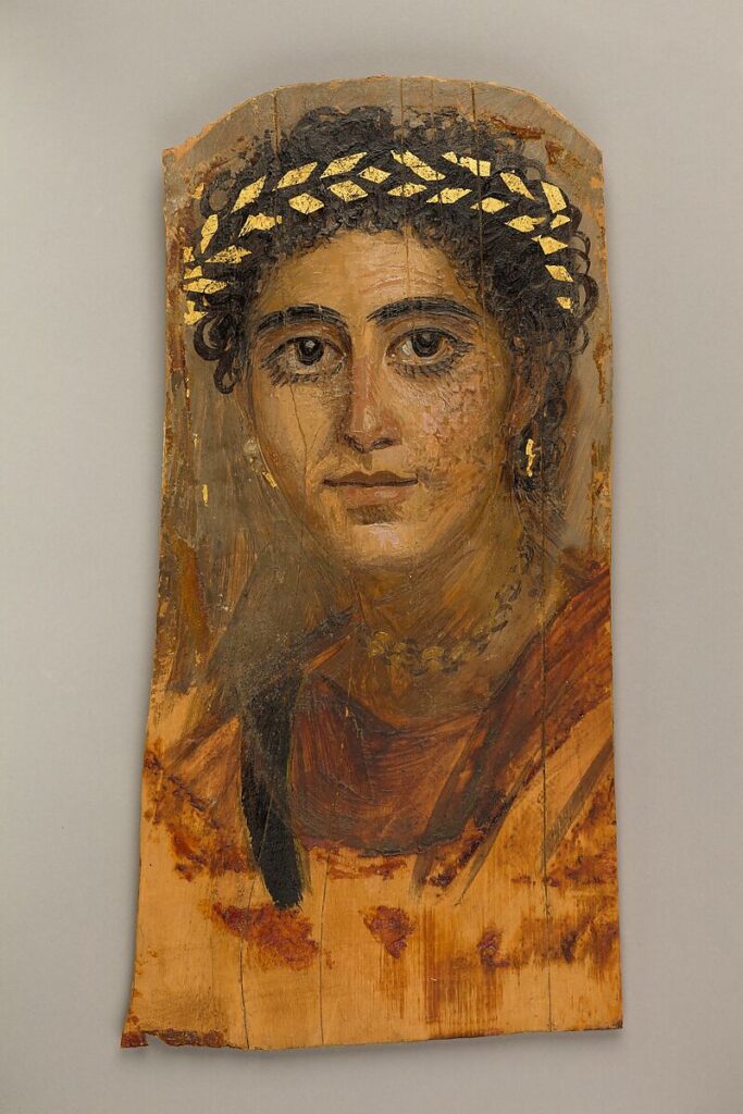 Met Museum encaustic portrait of a young woman in red with gilded wreath.
