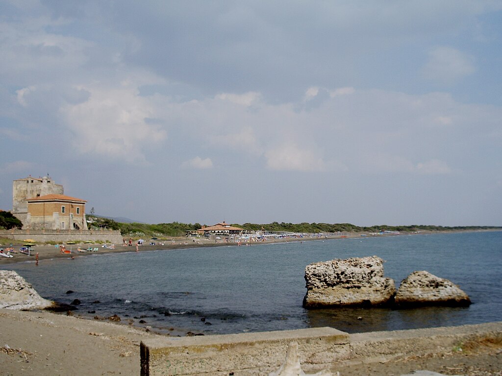 Remains of the Roman harbour at Cosa with concrete blocks along the shore.