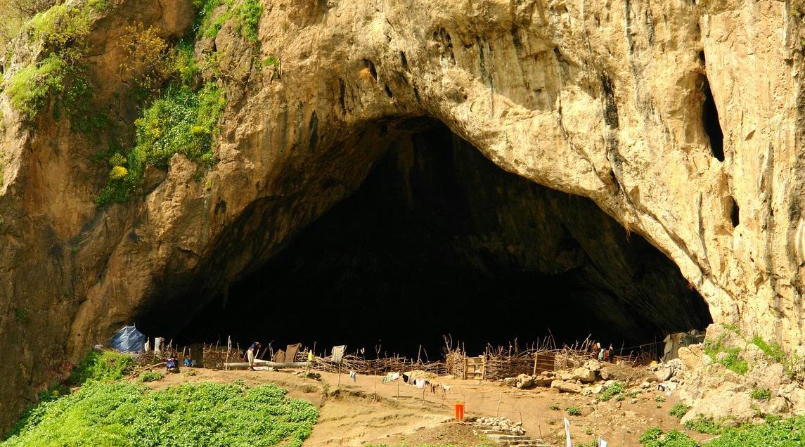 Sunlit cliff face with the entrance to Shanidar Cave