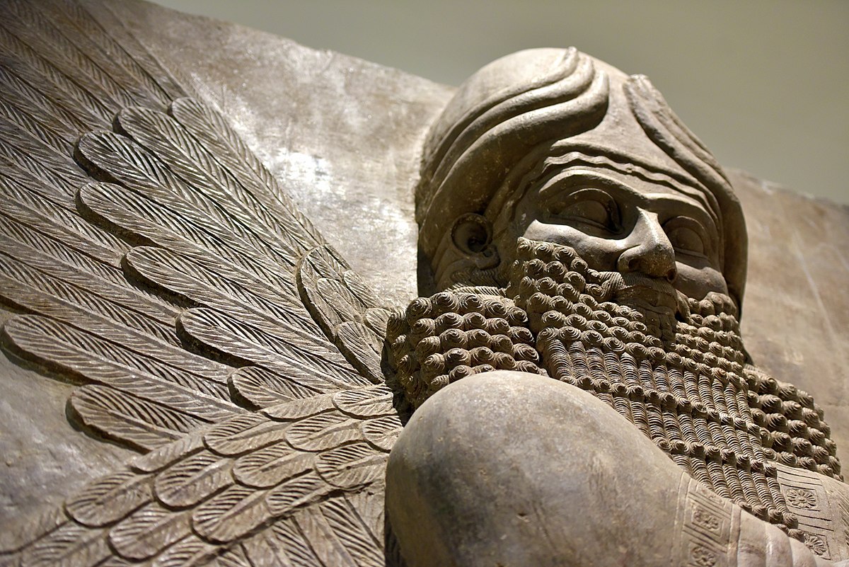 Human-headed winged Apkallu relief with rosette motifs.